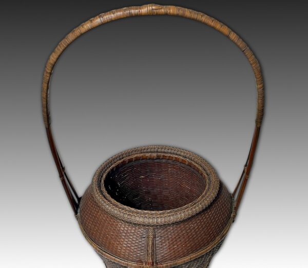 Waisted vase form hoop handle basket